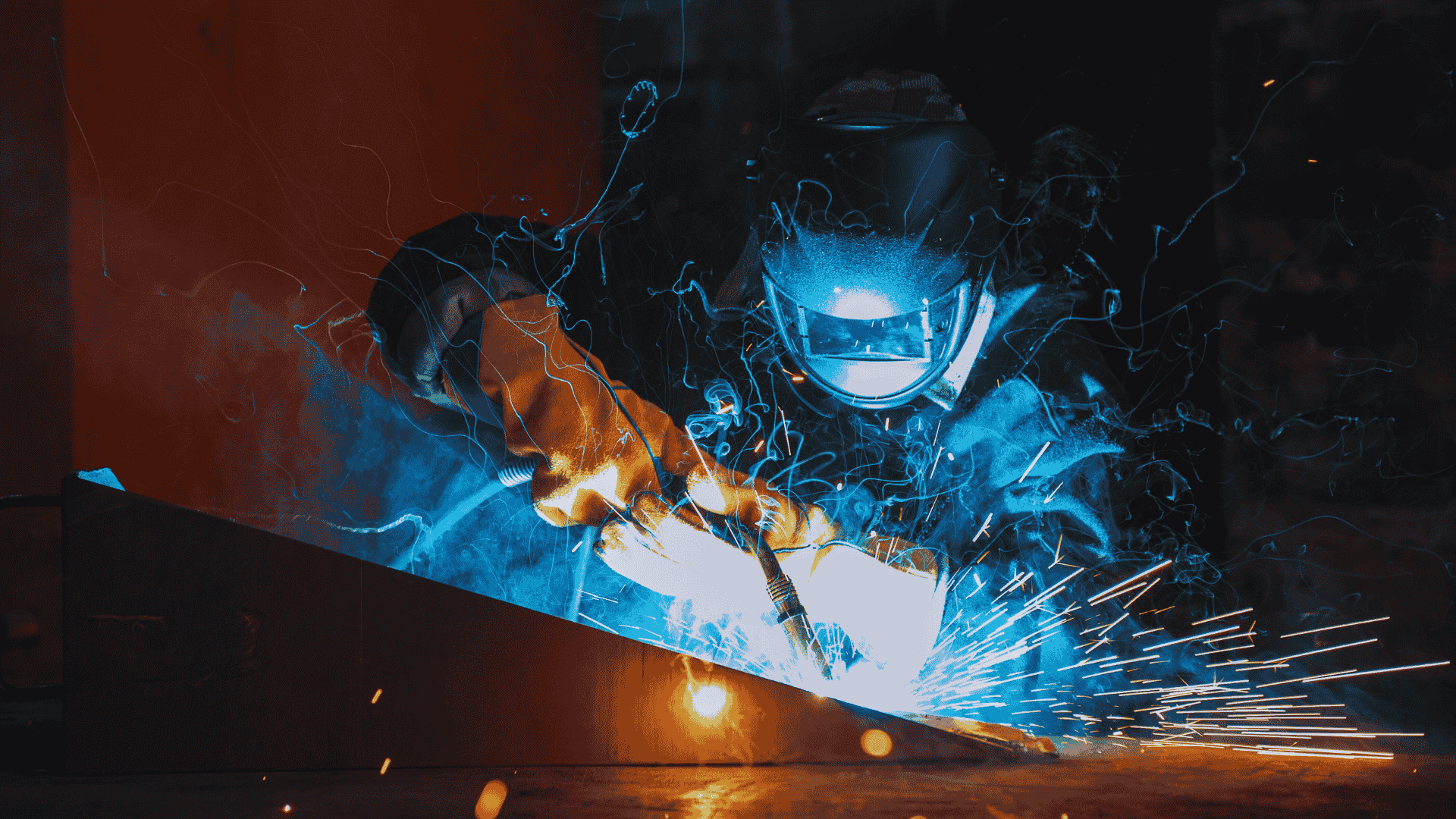 Welder working on a custom railing project at Proshield Metal Works in Edmonton, using high-quality steel and aluminum.